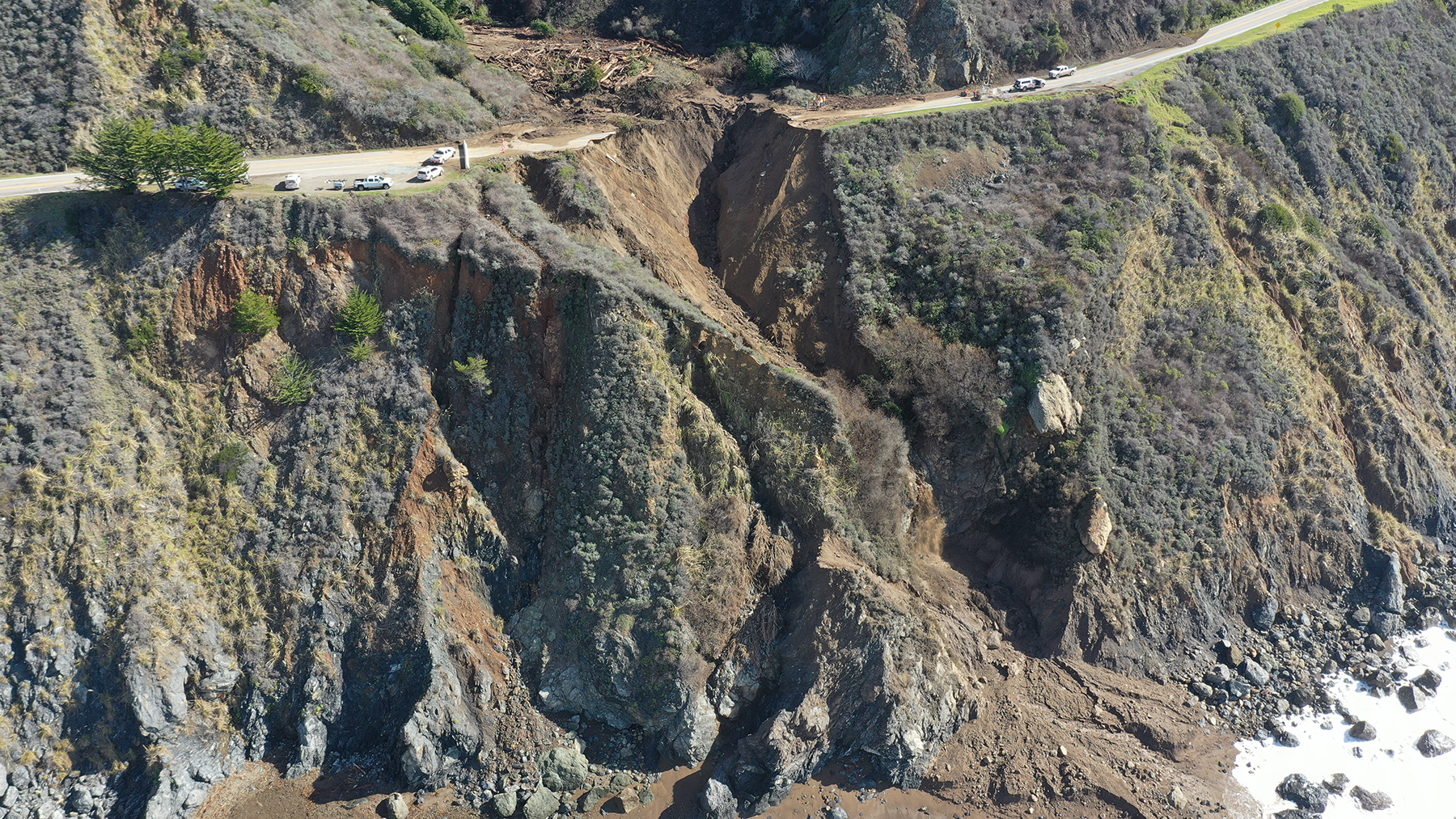 aerial of washed out road on cliffside