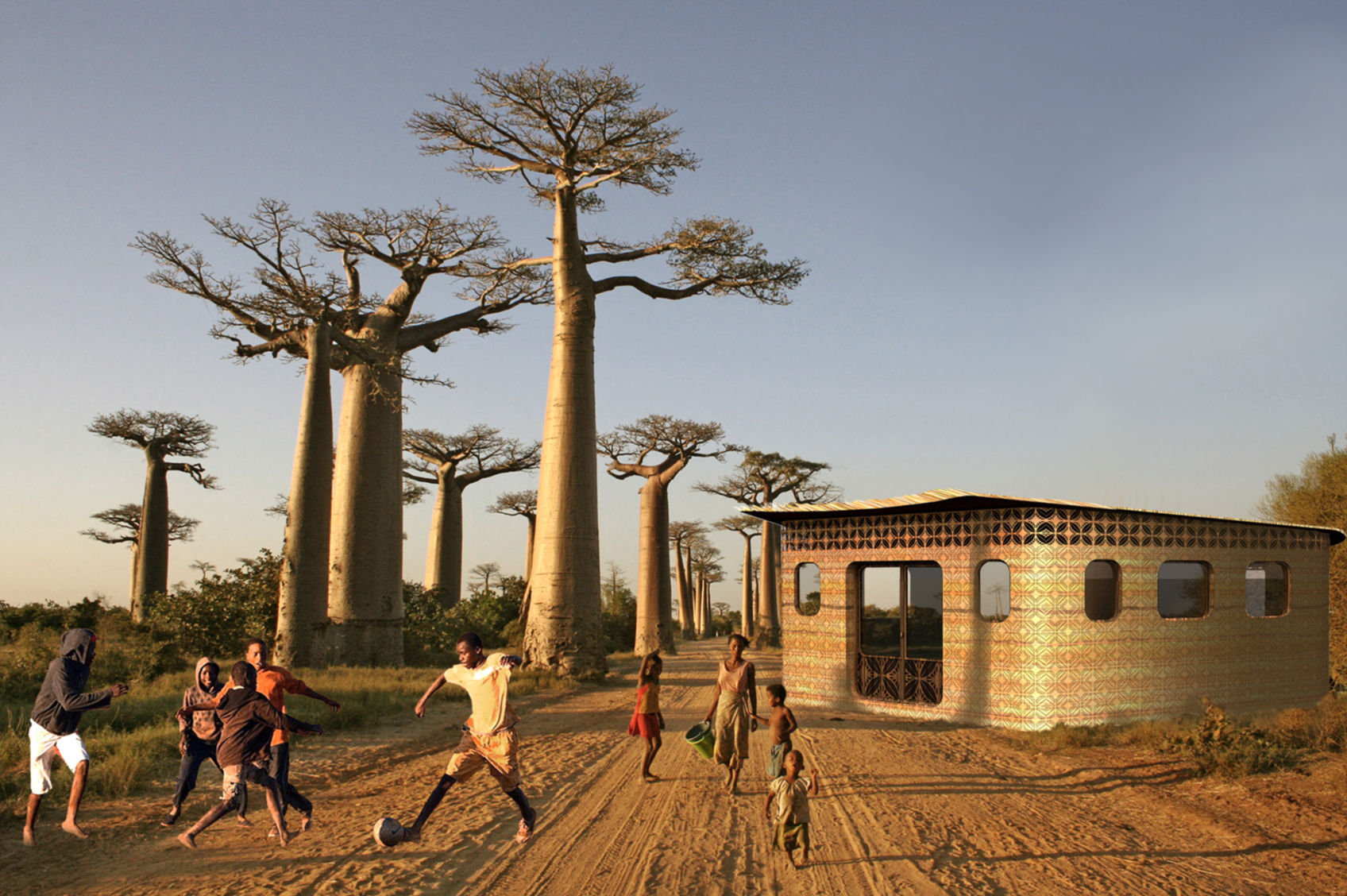 children play soccer in front of a school in the sand with trees in the distance