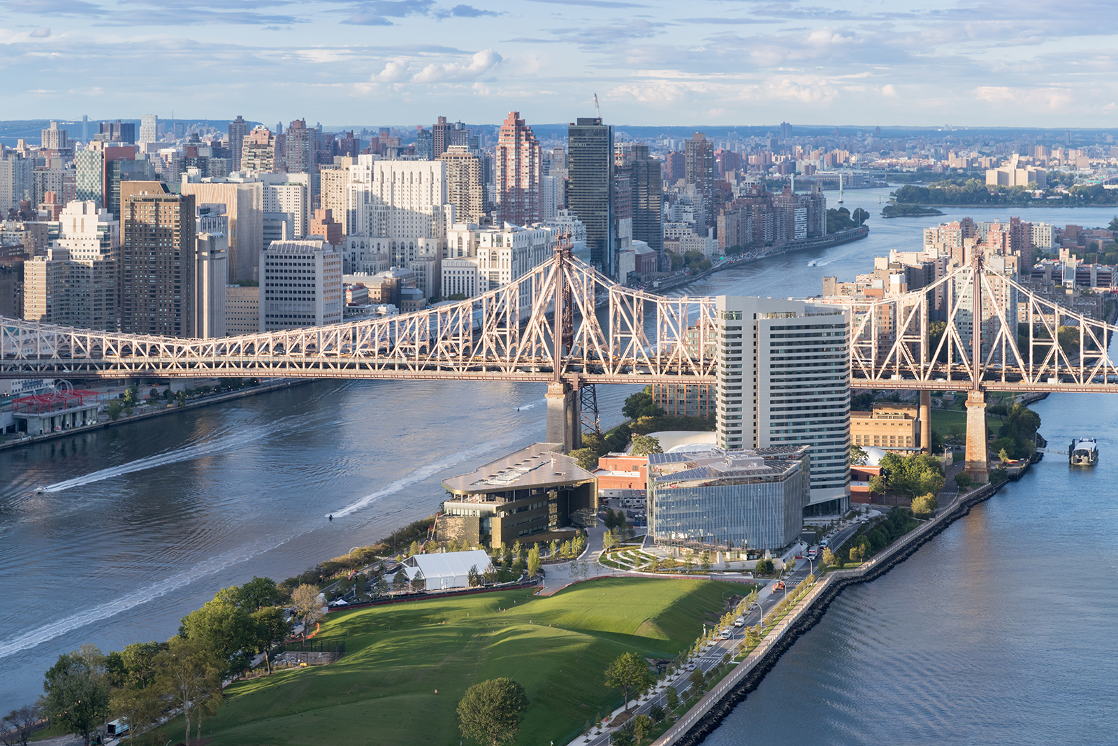 looking at an island in the middle of a river with a large bridge connecting both shores and the island