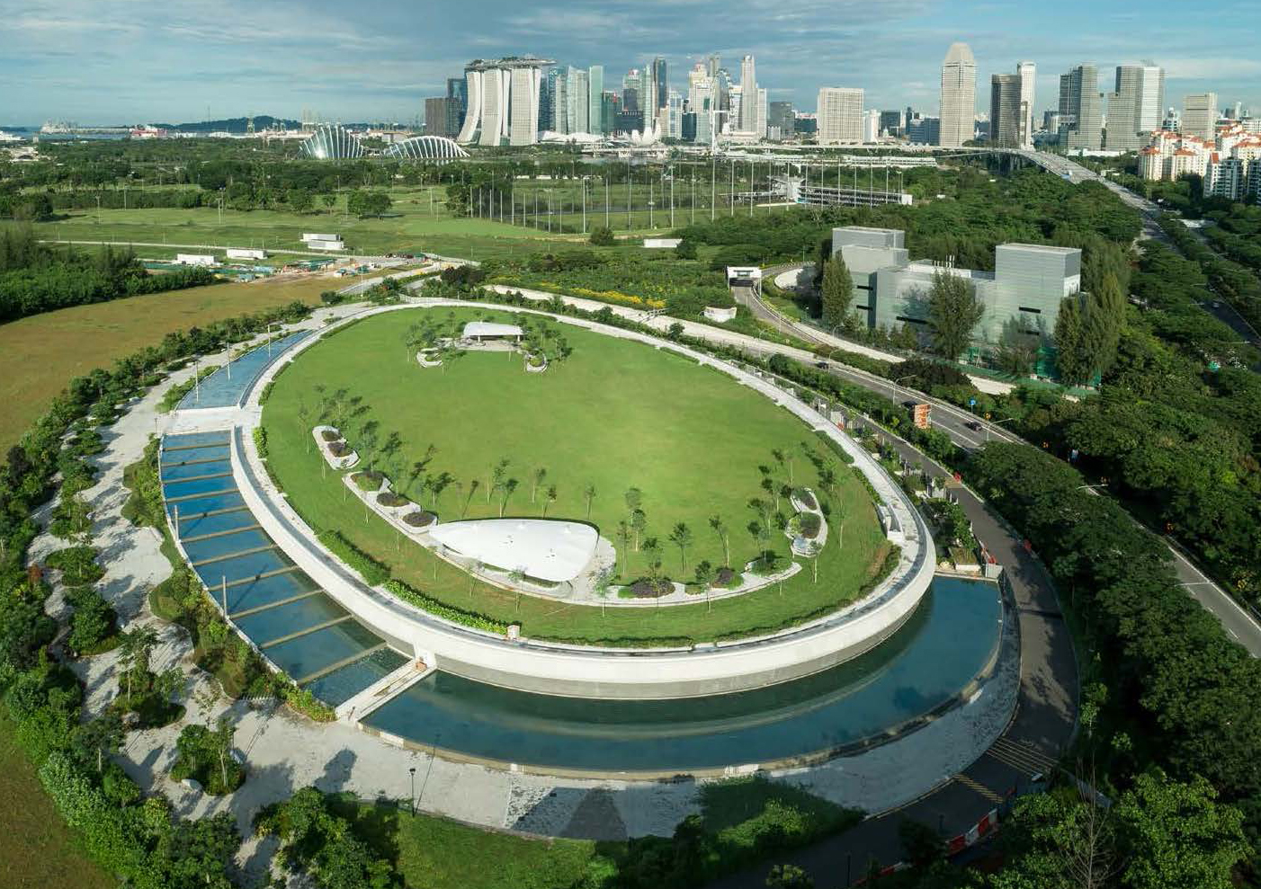 looking down on a circular, ground level park that is hiding a desalination plant