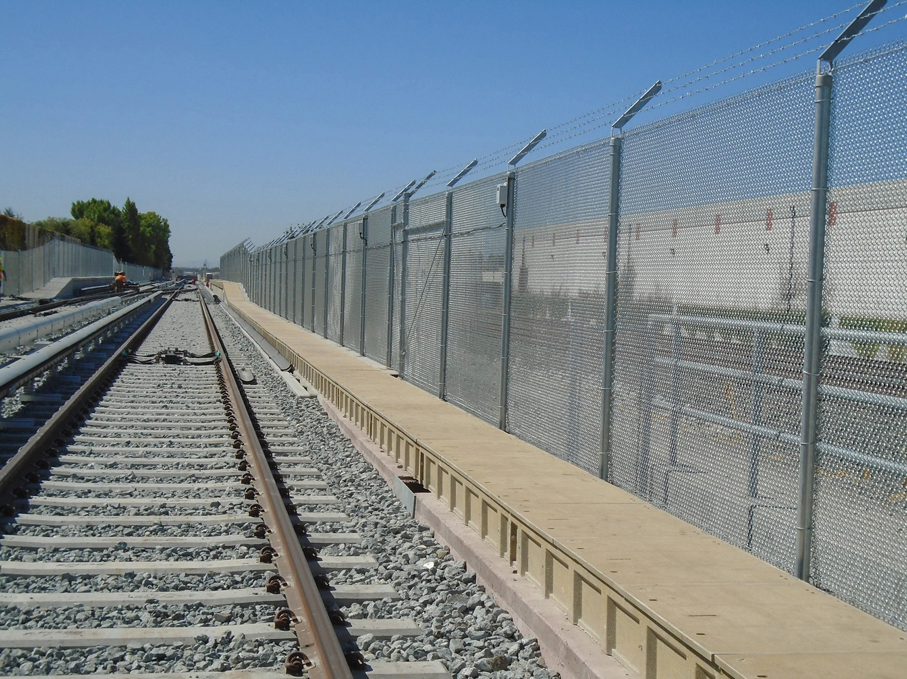 photographing showing the fence separating the BART and Union Pacific railroad tracks on the Berryessa extension