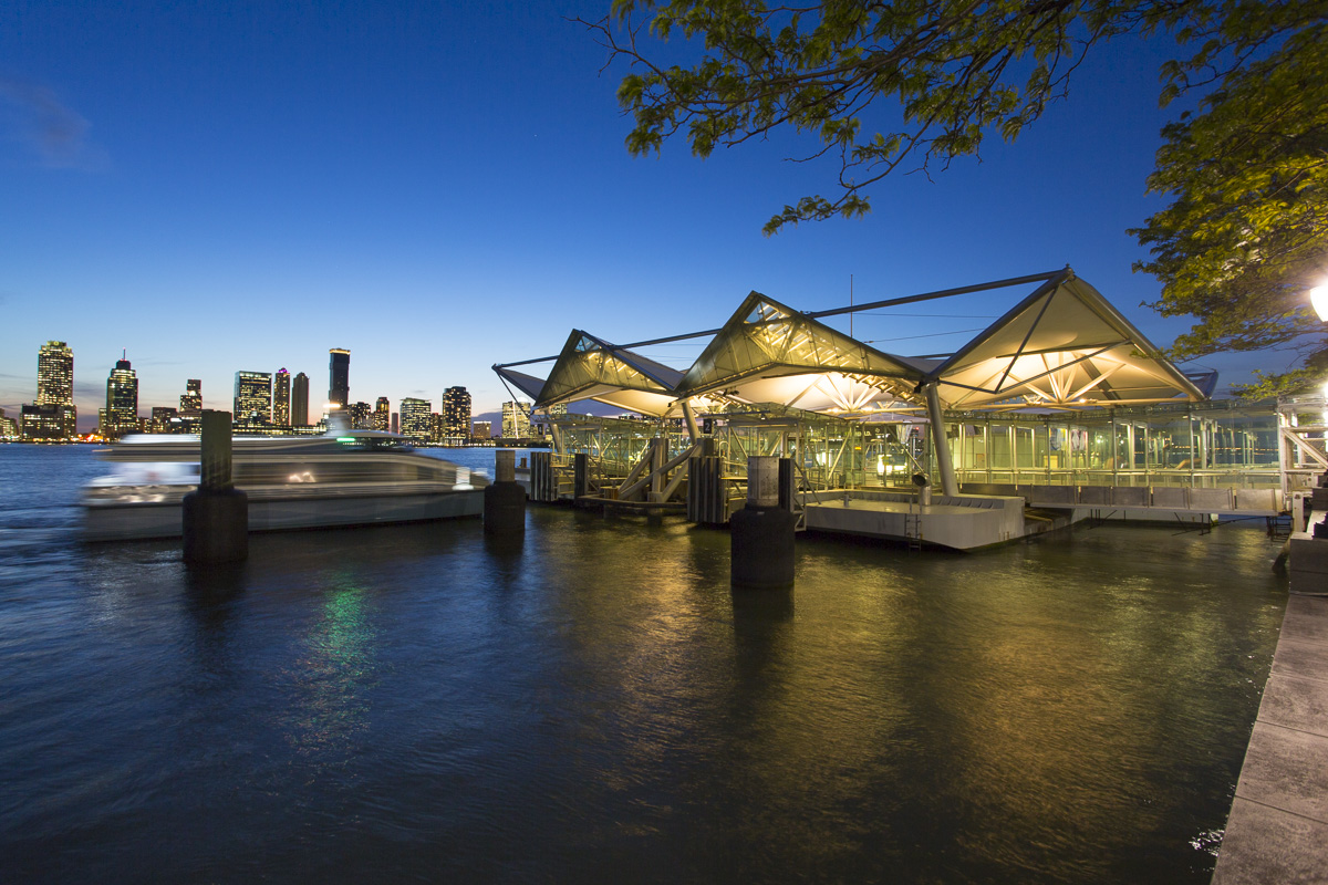 a floating ferry landing is lit up at dusk