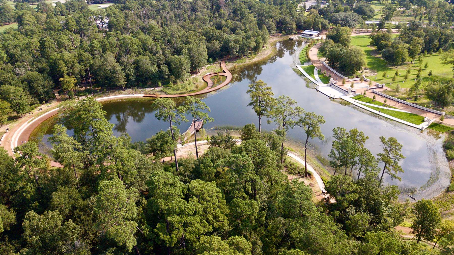 photo of the irregular-shaped lake surrounded by trees and walkways