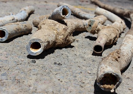 sections of old lead pipe covered in dirt