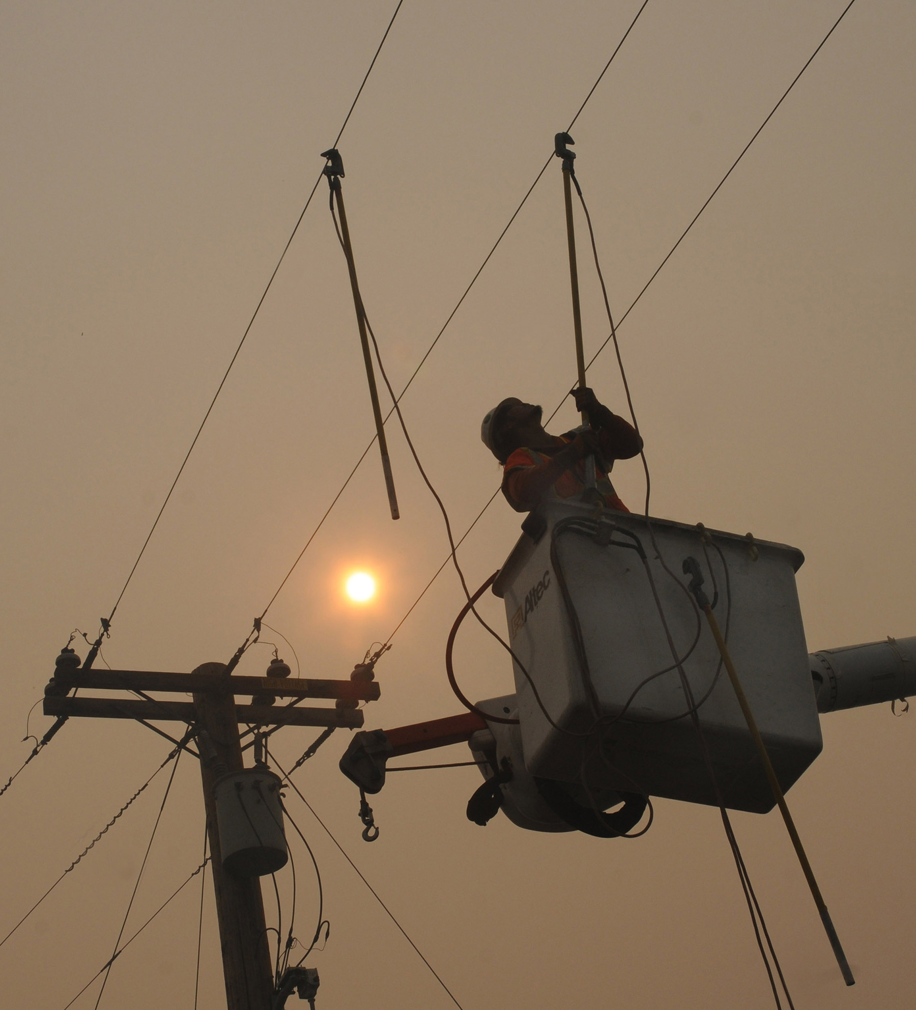 worker working on overhead power lines