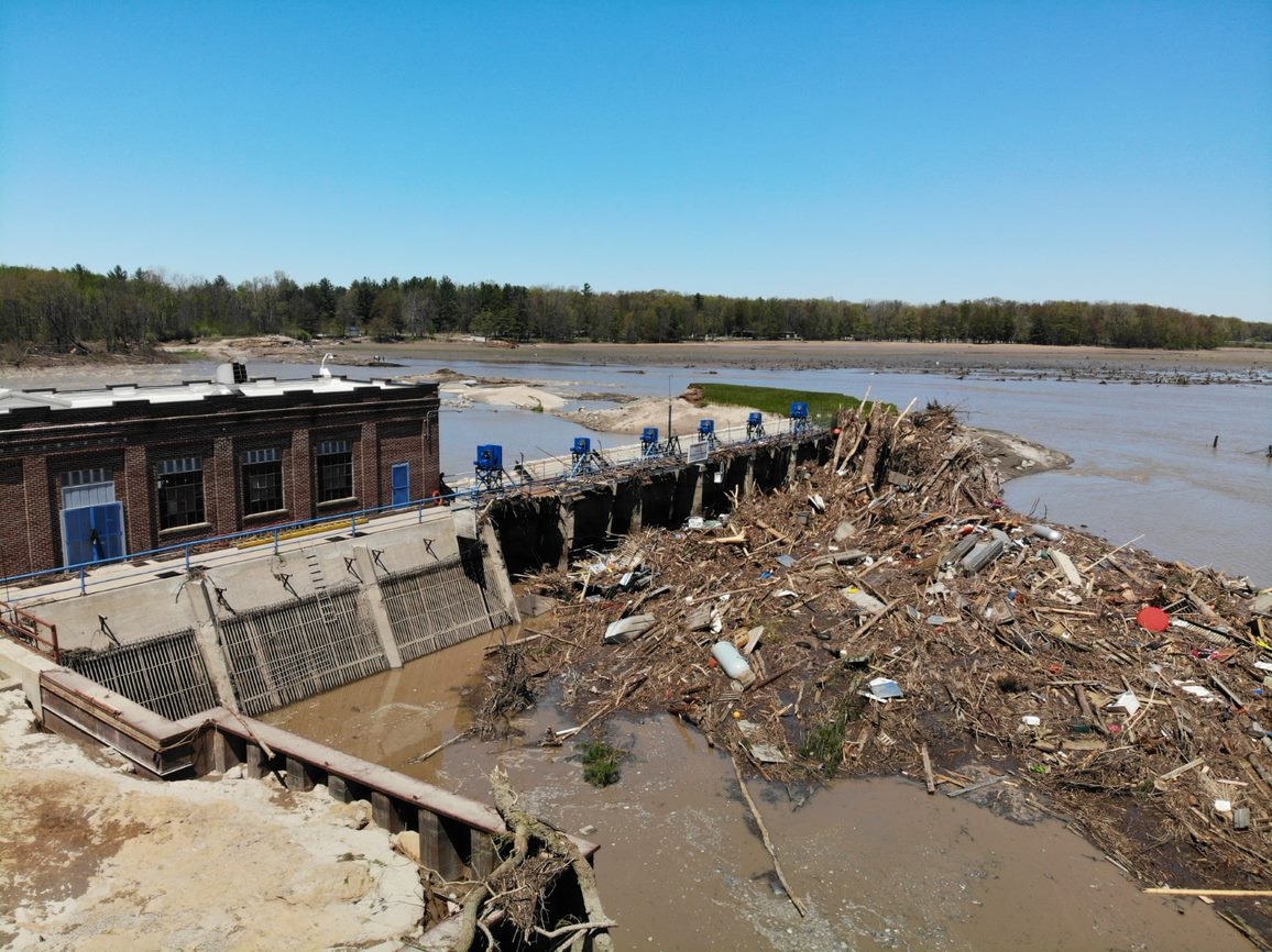 Sanford Dam powerhouse and spillway with breach in the background