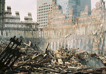 The remaining section of the World Trade Center is surrounded  by a mountain of rubble following the September 11 terrorist attacks.