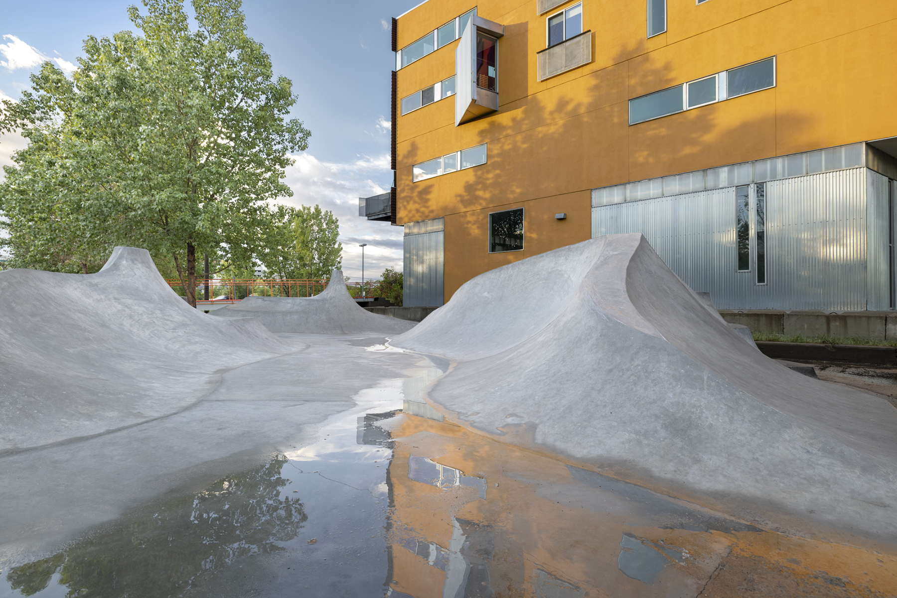 skateboard park with standing water showing drainage path