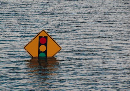 partially submerged traffic sign showing lights ahead
