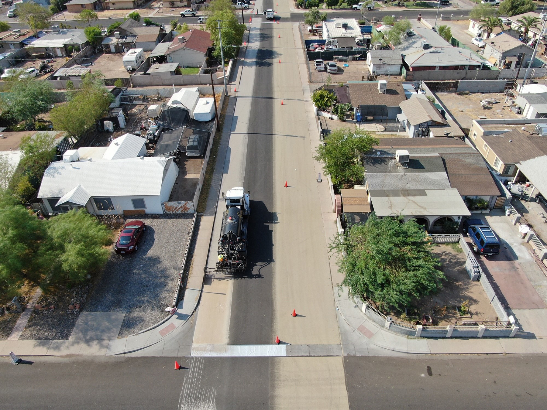 a truck applies sealant onto a neighborhood road