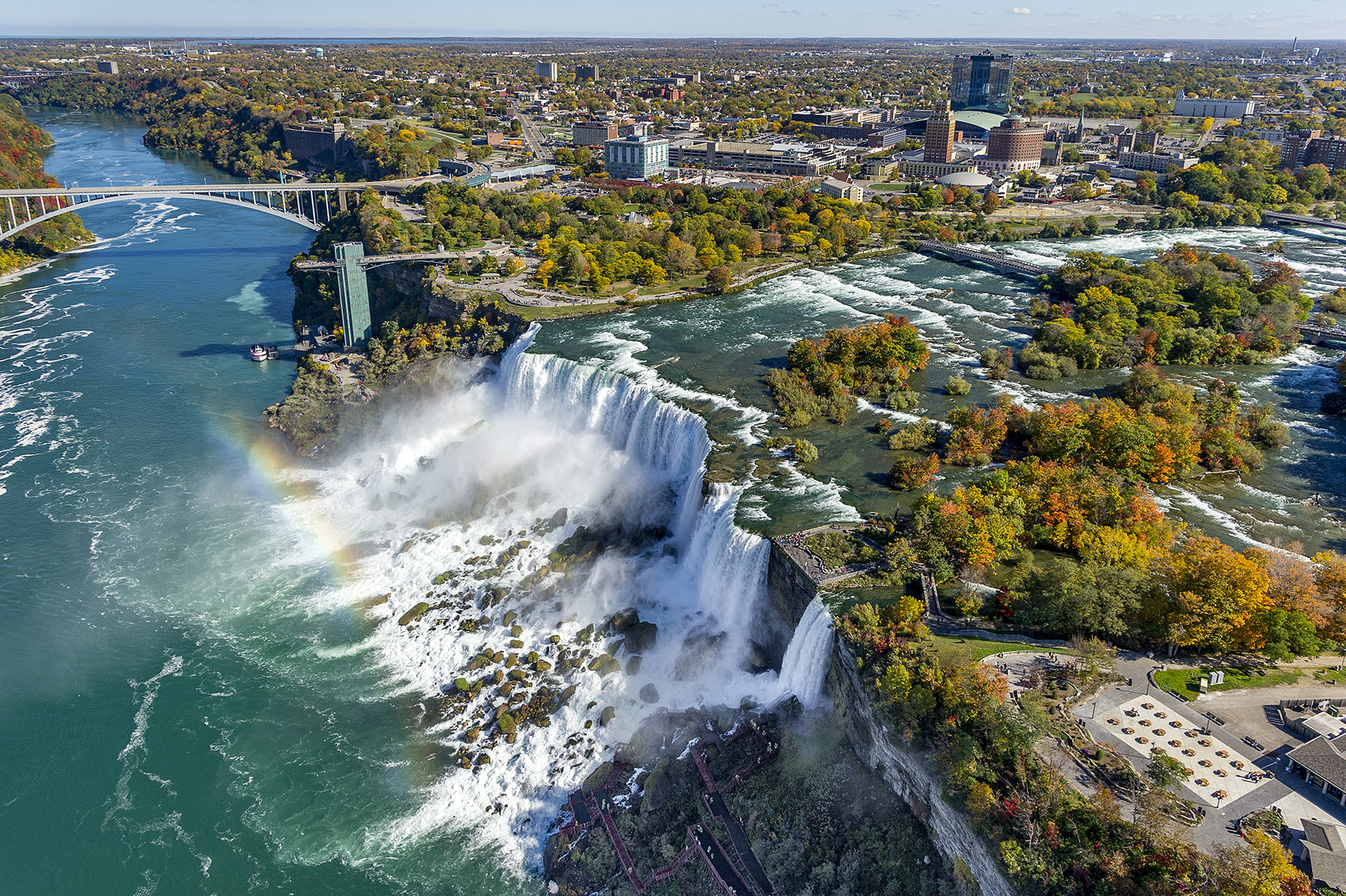 waterfall with rainbow and bridges and trees