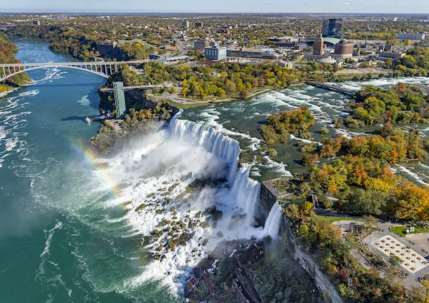 waterfall with rainbow and bridges and trees