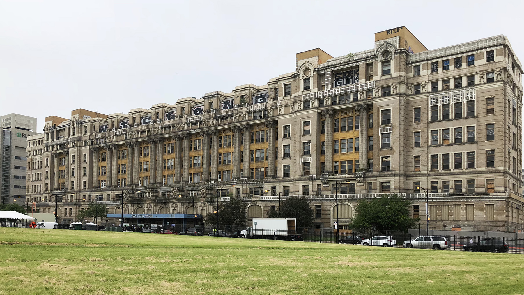 white and yellow façade of a multistory building that is in need of cleaning