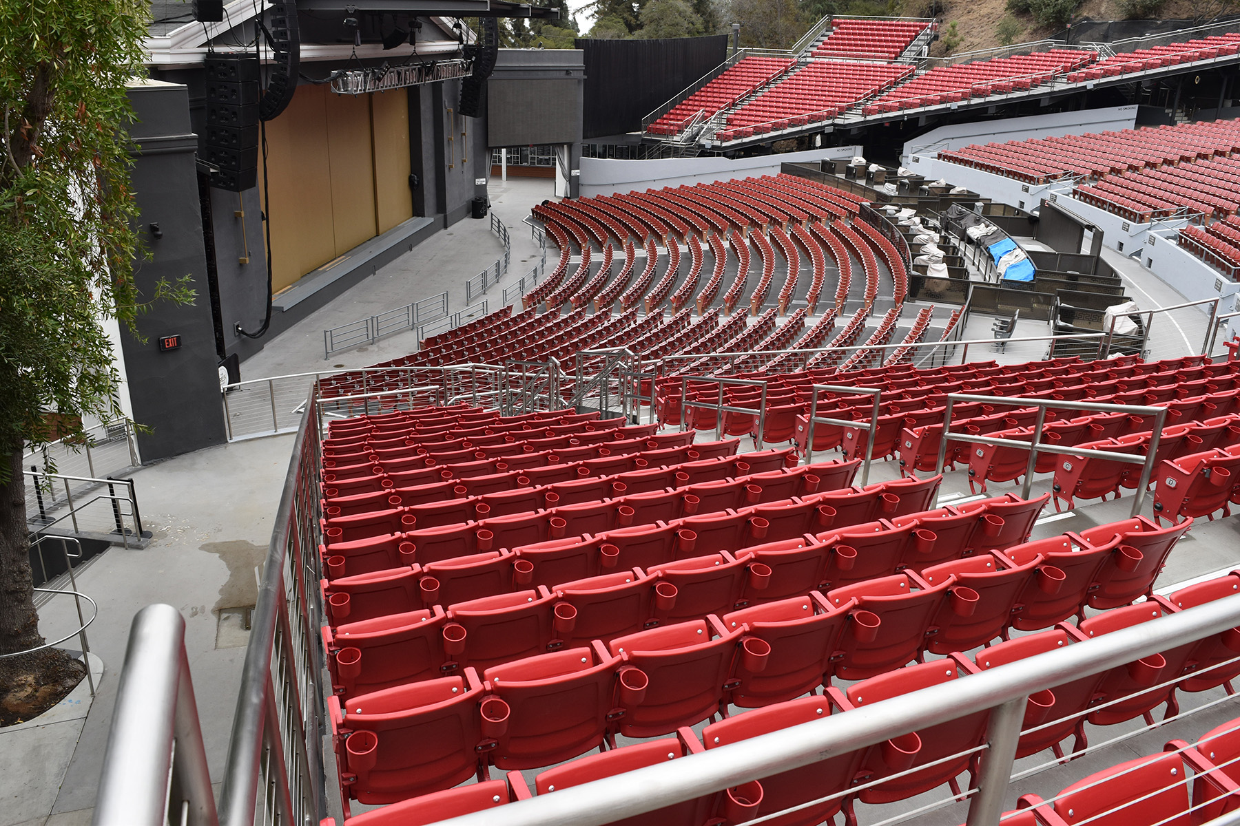 outdoor tiered seating with a stage and sound equipment