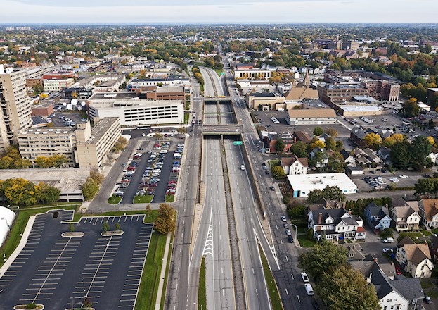 six-lane highway with buildings on both sides of it
