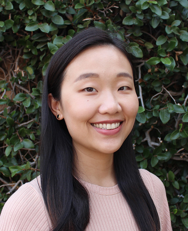 smiling woman in pink sweater