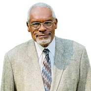 man in suit and tie smiling at the camera
