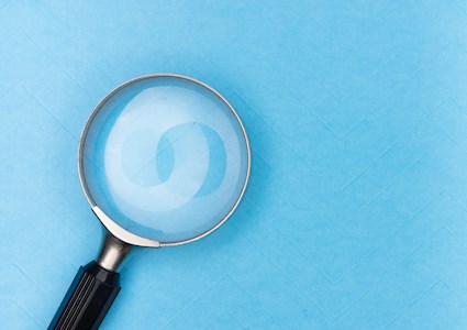 magnifying glass on blue bacground