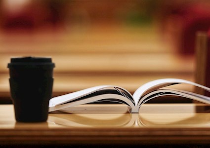 books and coffee cup on a table