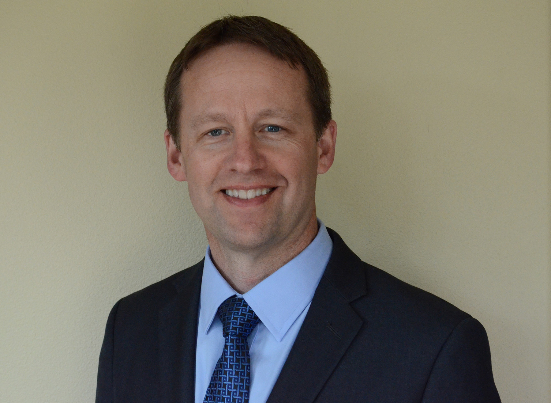 man in blue suit with a blue shirt and blue tie