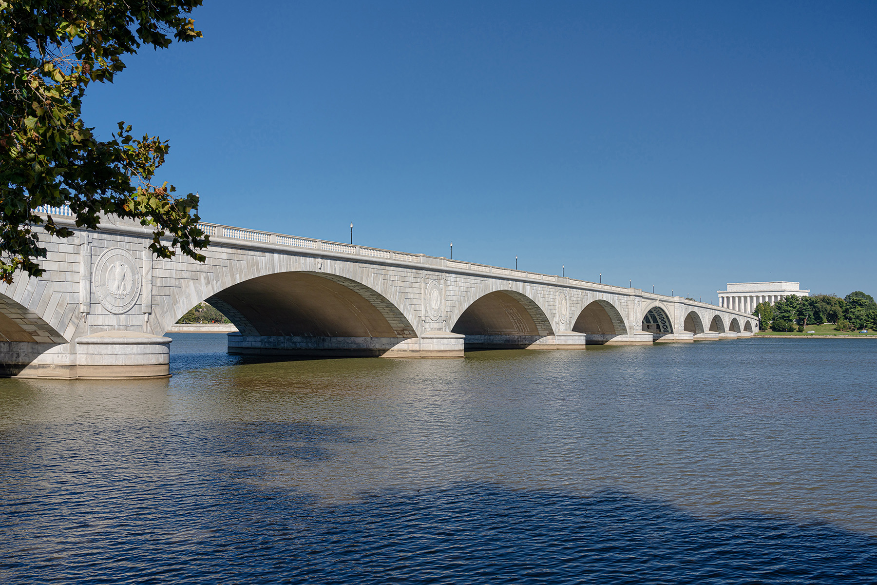 white granite bridge spanning a body of water