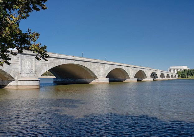 white granite bridge spanning a body of water