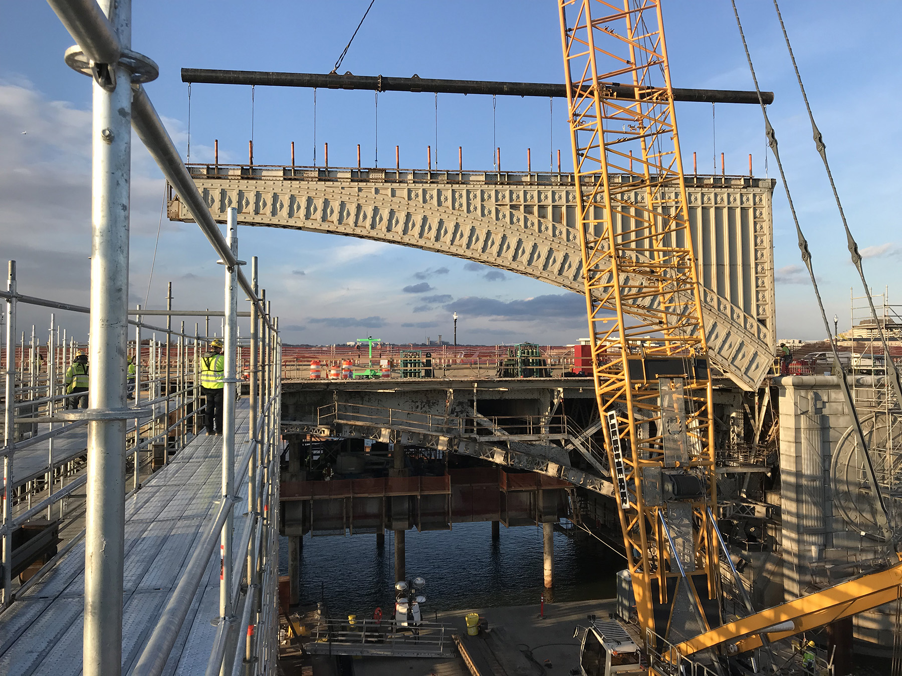 steel framed portion of a bridge being fitted in place by use of floating barges