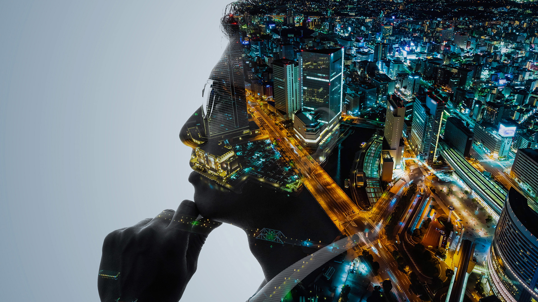 profile picture of a man with a night time city scape superimposed on the man’s image