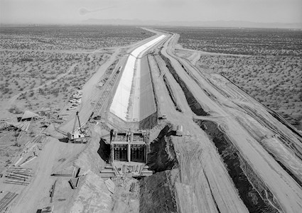 picture shows the construction of an underground water canal in a desert 