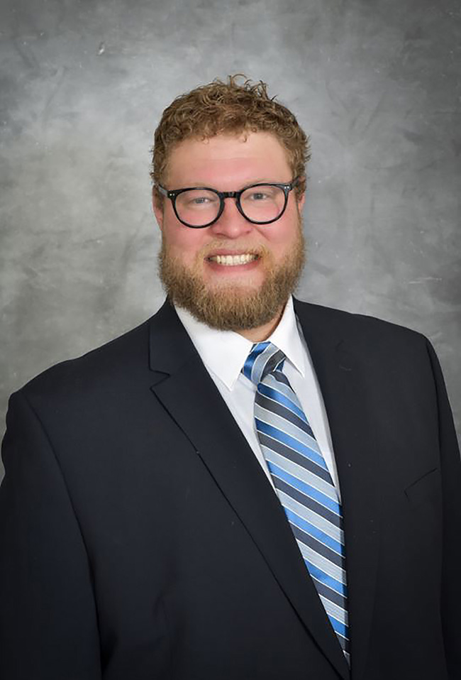 man wearing blue suit and striped tie