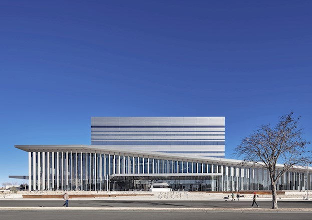 linear building with vertical stripes on its façade. it is supposed to resemble a bird’s wing