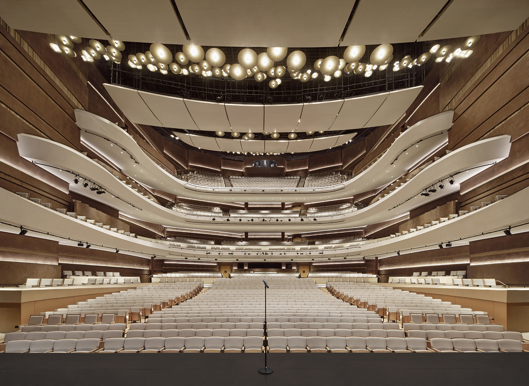 a multi story room full of seating and balconies