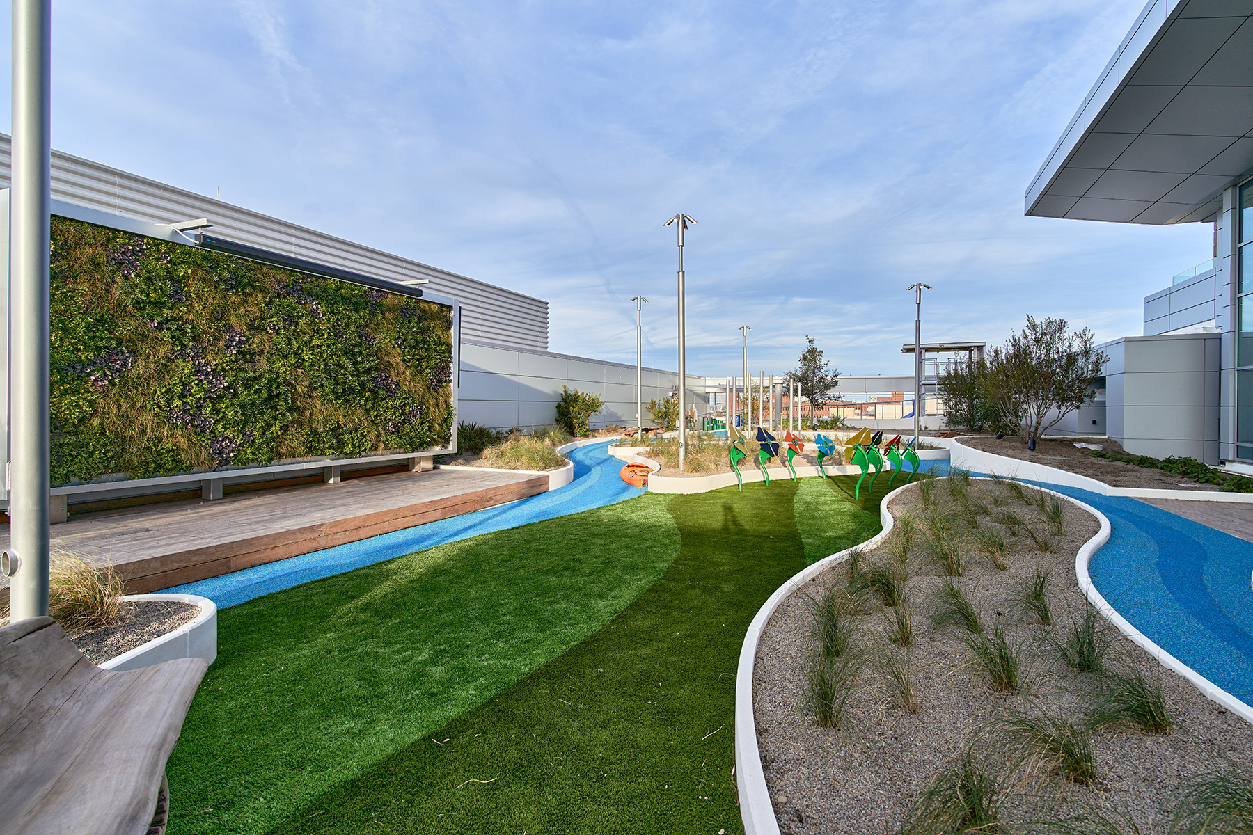 children’s play area showing paths, grass, and green plantings