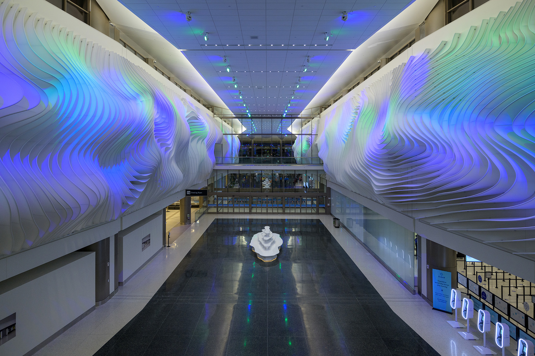 art installation on two walls. the art resembles the way light affects the weathered rock formations of a canyon.