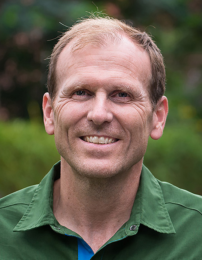 man in green shirt smiling