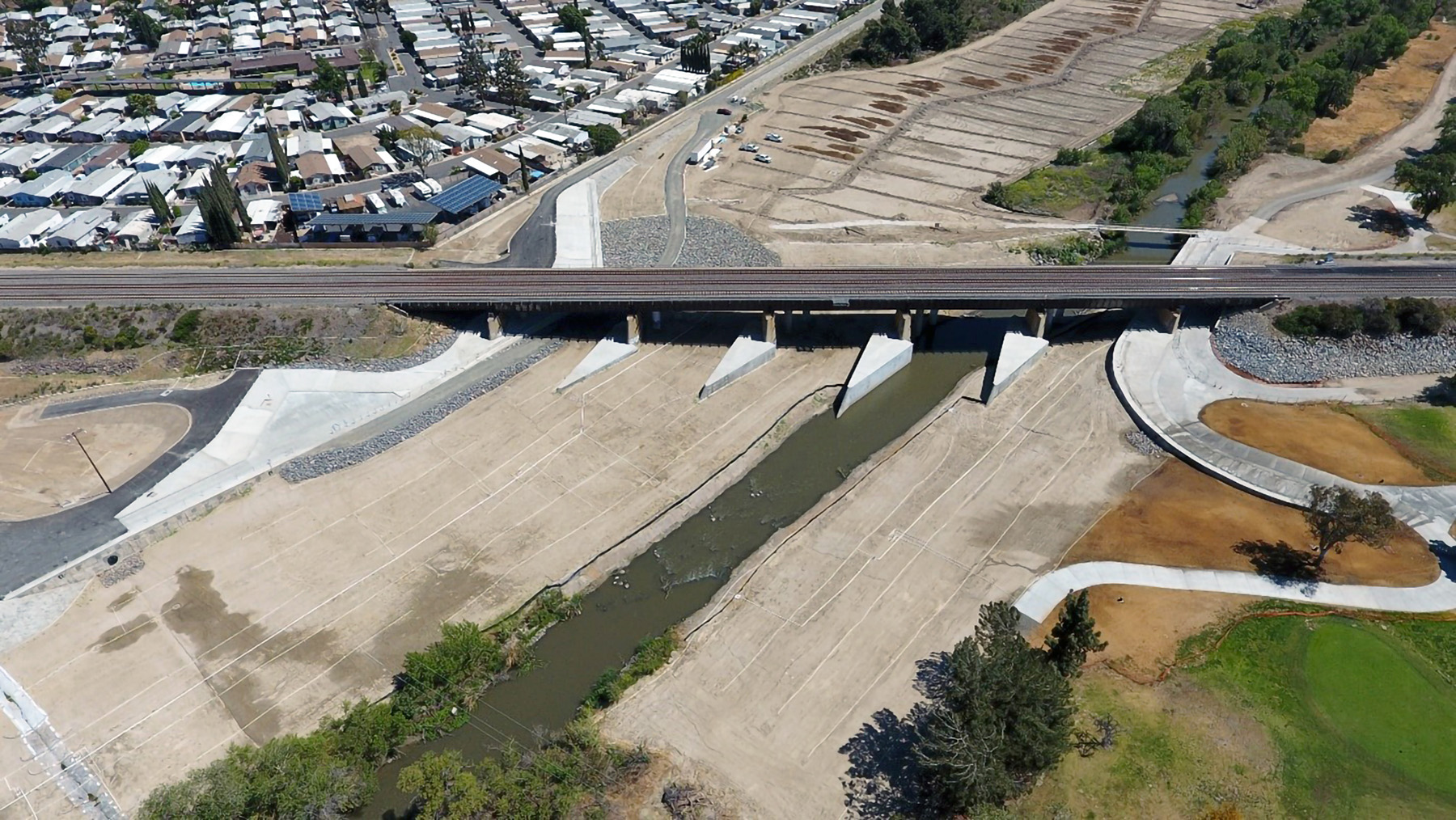 Photograph shows scour protection features installed at the base of the bridge. 