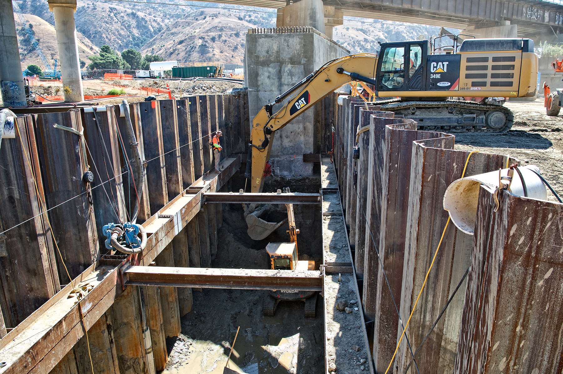 Work crew excavates inside a cofferdam. 