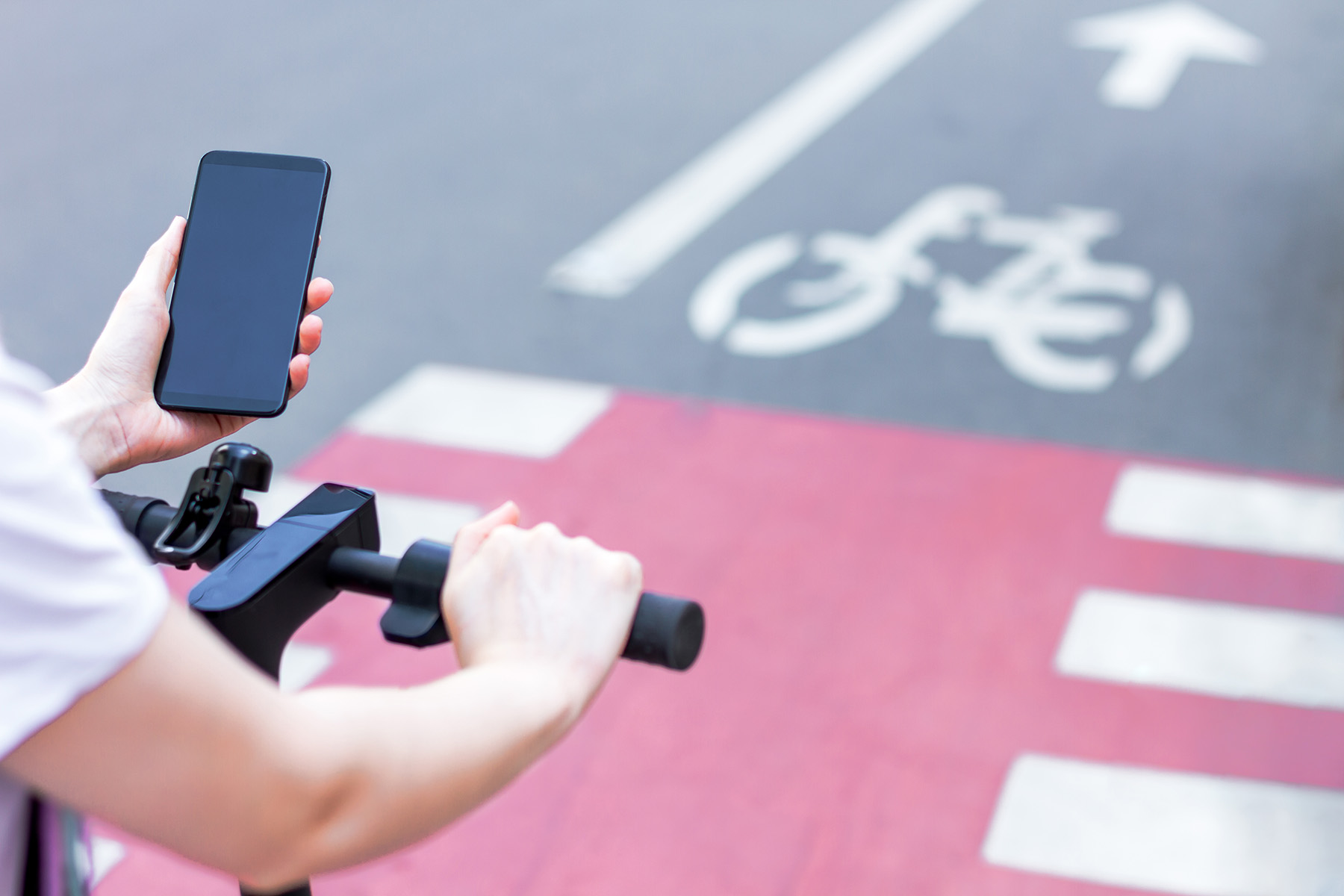 person on bicycle holding a phone