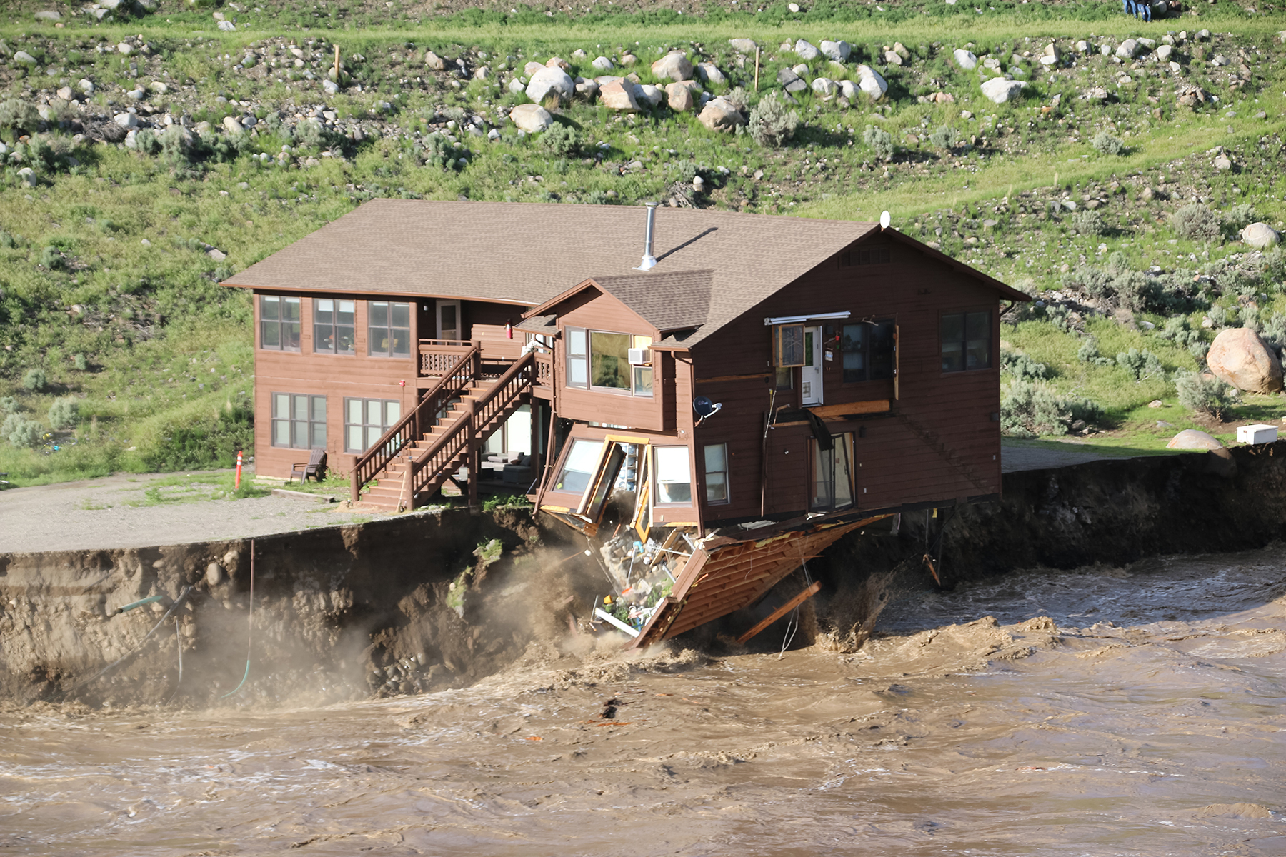 A building owned by the National Park Service and used for employee housing collapsed into the Yellowstone River just downstream of Gardiner, Montana, and was eventually swept away. (Photograph courtesy of Gina Riquier)
