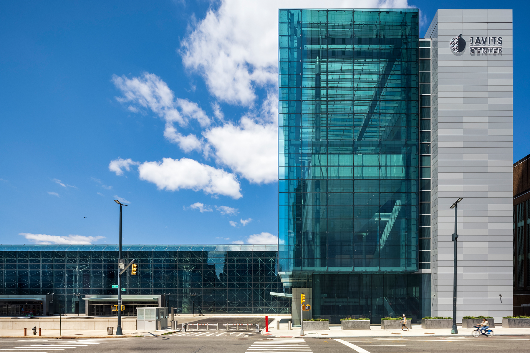 Multilevel concrete, steel, and glass structure set on a city block.