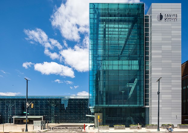 Multilevel concrete, steel, and glass structure set on a city block.