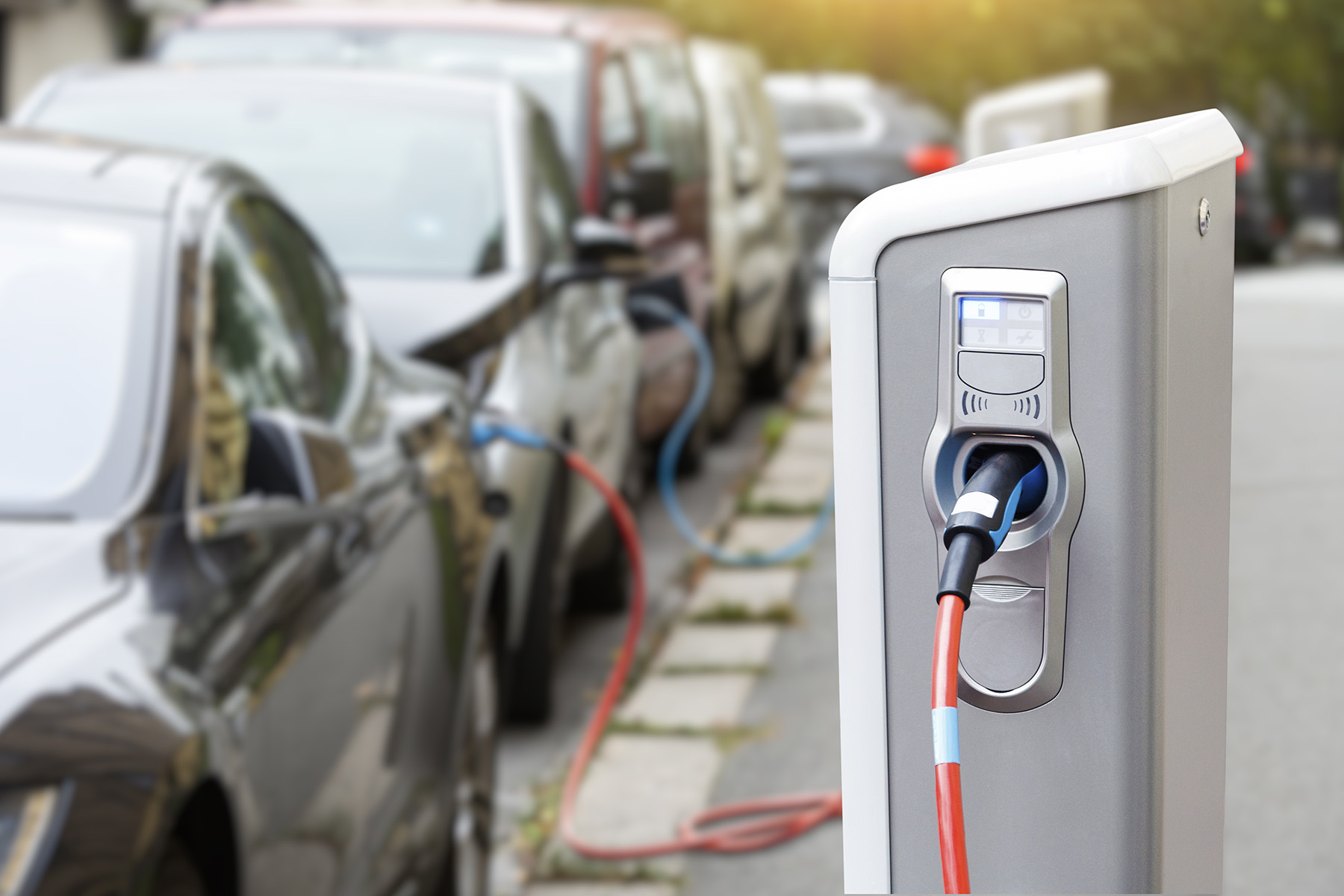 Electric cars lined up waiting for a charging station