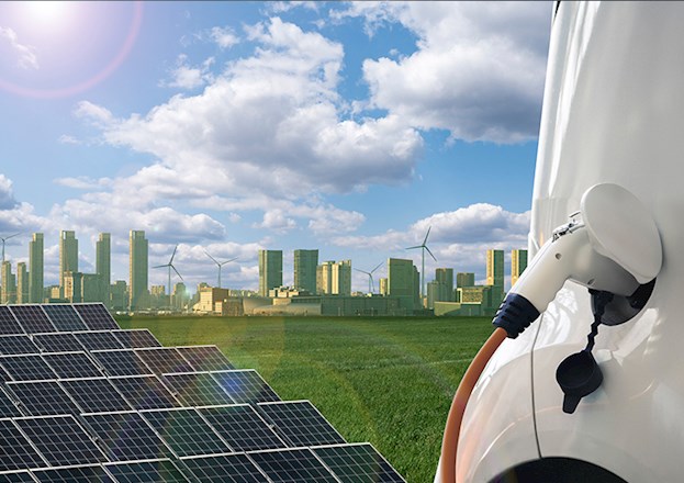 Solar panels and a nozzle filling a gas tank in the foreground and a cityscape and windmills in the background.