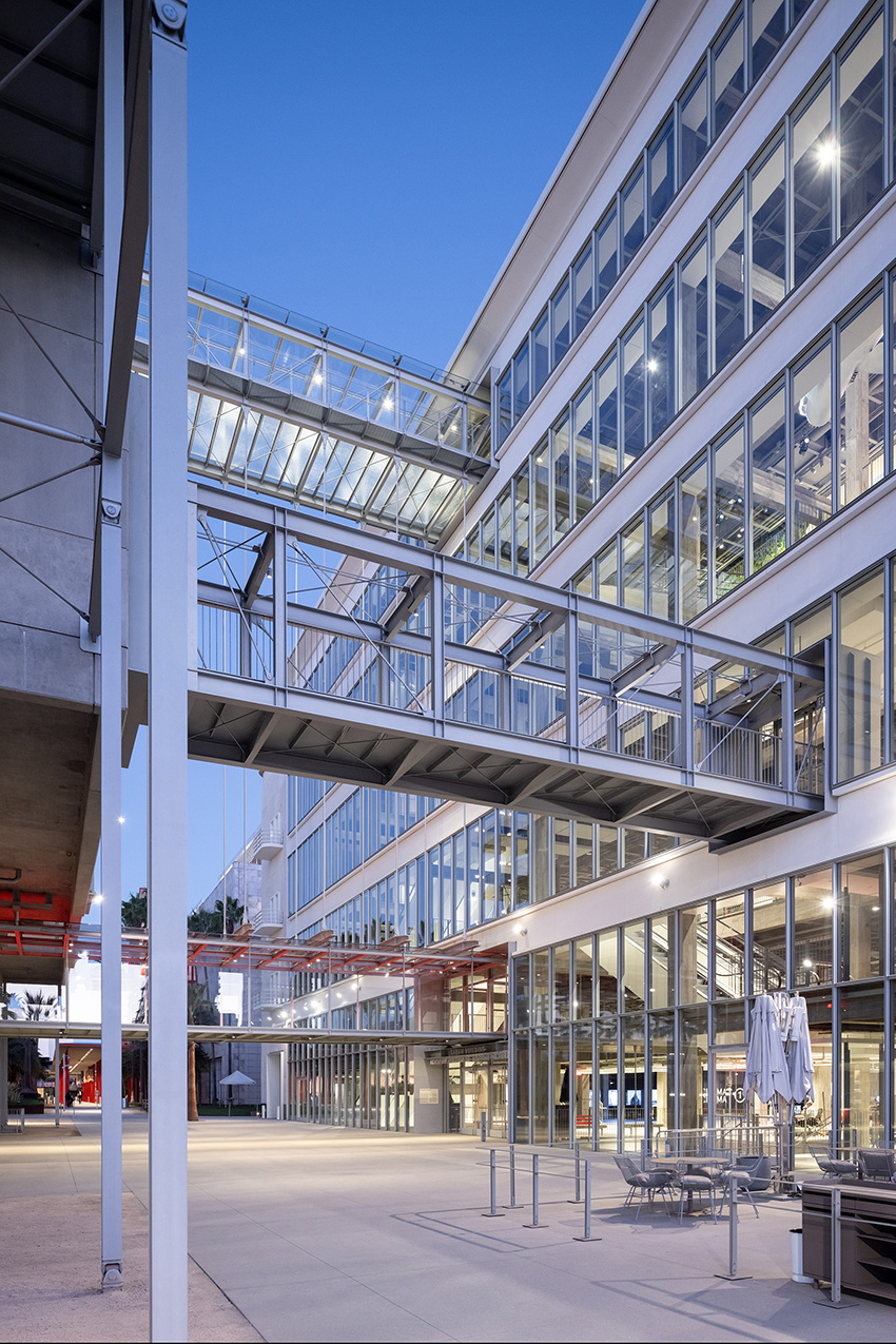 Glass and steel walkways connect to buildings
