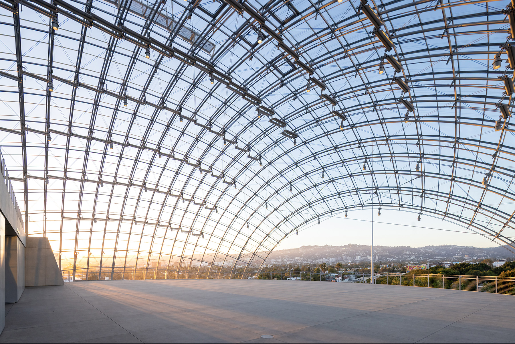 Spherical glass canopy covers a concrete slab