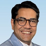 man wearing glasses and suit