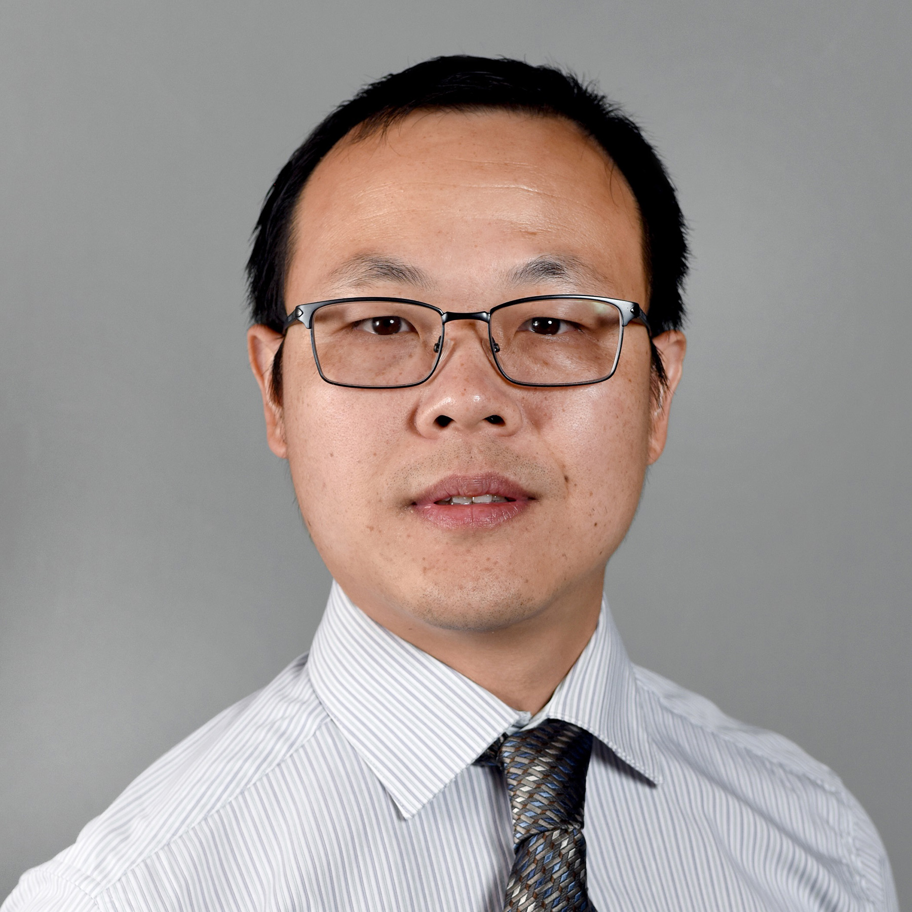 man in tie and white shirt wearing glasses