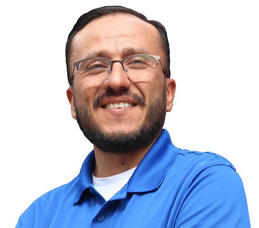 man in blue polo shirt with white writing.