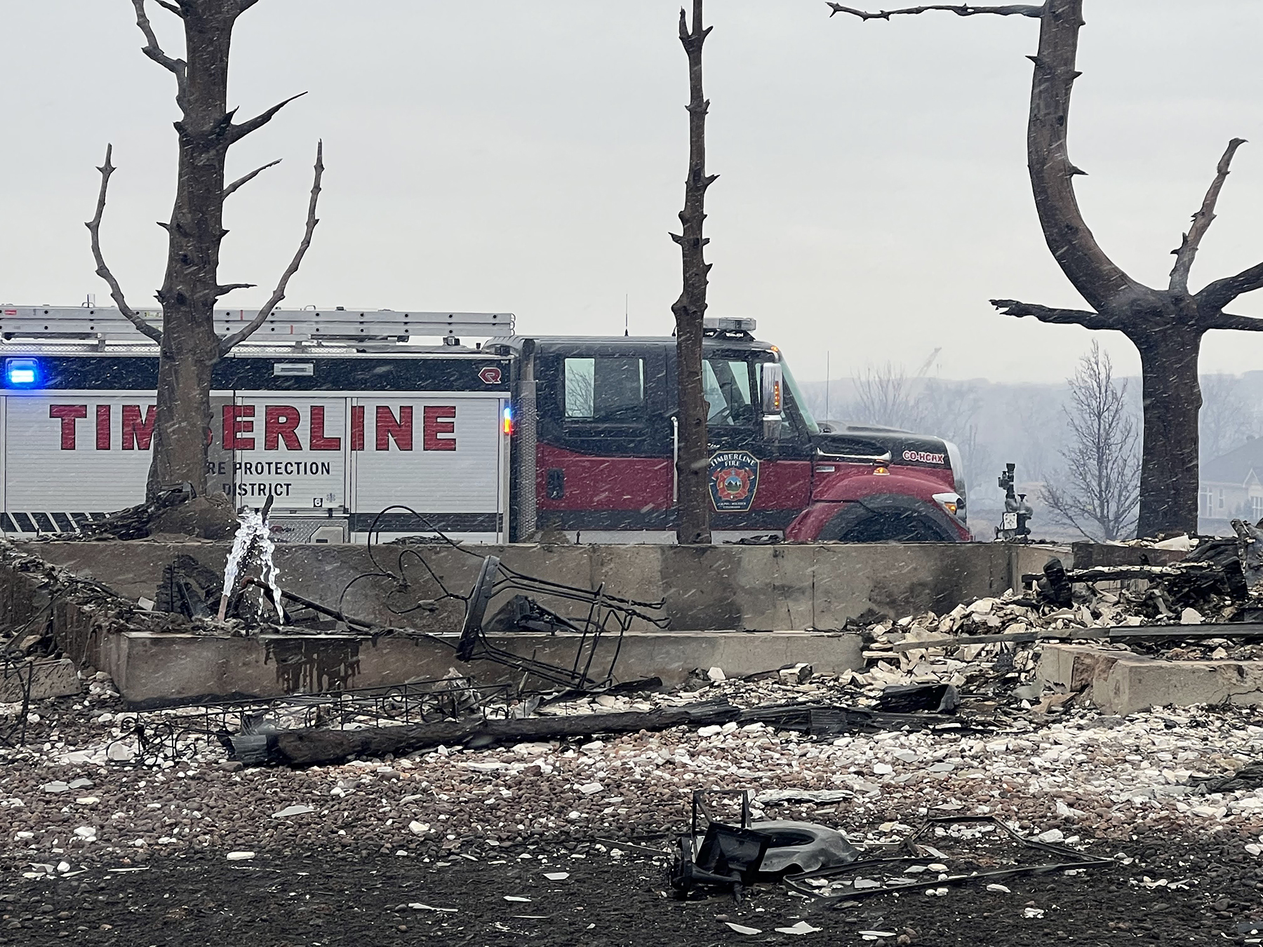 The entire Sagamore neighborhood in Superior, Colorado, was destroyed during the Marshall Fire in late December 2021. This photo shows water discharging from an open pipe into the foundation of a burned property. (Courtesy of Brad P. Wham)