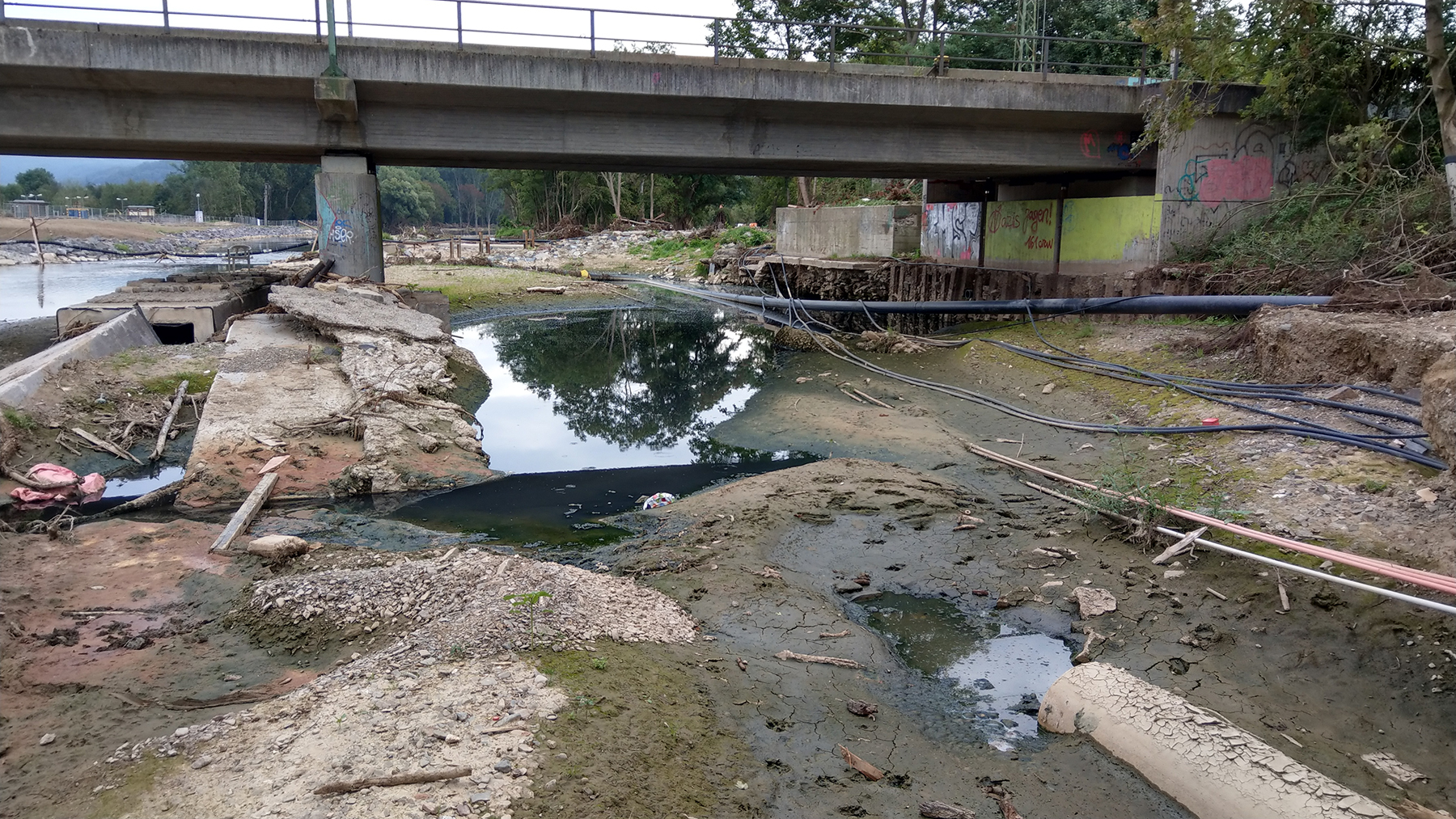 After the 2021 flood in Ahr Valley in Germany, 134 people were killed and extensive damage occurred in villages along the river. Here, underground cables and pipes were uncovered, while piles of sediment and woody debris lined the riverbanks. (Photograph courtesy of University of Göttingen/Michael Dietze)